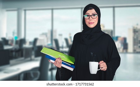 Office Woman - Arab girl on Abaya Hijab black dress in Middle East. Beautiful Arabic Emirati lady at inside a business boardroom. 
