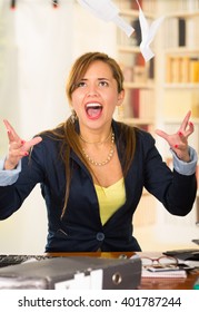 Office Woman Sitting By Desk Throwing Papers Up In The Air And Screaming 