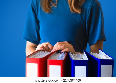 Office woman in suit dress with stack of ring binders for archiving documents over clean background. File, Ring Binder, Emotional Stress.
