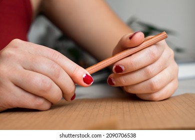 Office Woman's Hands Holding A Pencil With Chipped Red Nail Polish