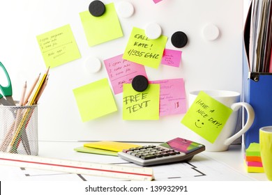 Office Work Area. Desk With Pink And Yellow 'Post It' Notes.