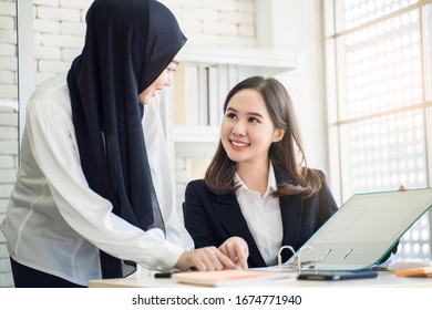 Office Work Place With Multiethnic Asian Female Muslim Workers Working Together As Team Using Strategy To Plan Work, Concept Of Diversity Of Culture Different Race Type Of People Co-working Together