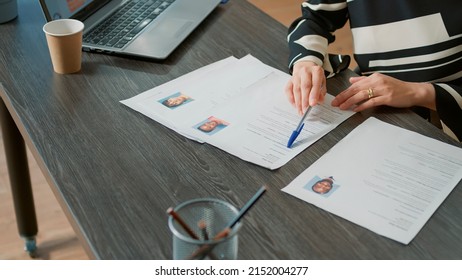 Office worker analyzing candidates cv and application form before attending job interview and hiring people. Recruiter searching on papers for person with business expertise. Close up. - Shutterstock ID 2152004277
