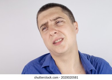 An Office Worker In A Blue Shirt Looks At The Camera. He Covered In Sweat Stains. The Man Has A Lot Of Stress, Accompanied By Increased Sweating. The Businessman Is Nervous And Sweats A Lot.