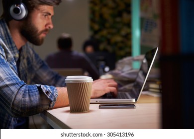 Office Worker With Coffee At Desk Working Late On Laptop - Powered by Shutterstock