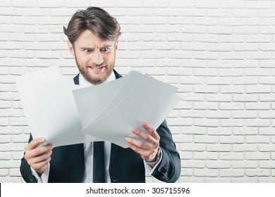 Office worker confused with a lot of paperwork - Shutterstock ID 305715596