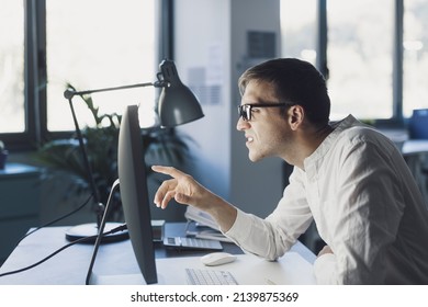 Office Worker With Eyesight Problem, He Is Trying To Focus On The Computer Screen