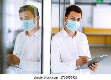Office worker with face mask working in the office. The concept of preventing the spread of the epidemic and treating coronavirus, pandemic in quarantine city. Covid-19.