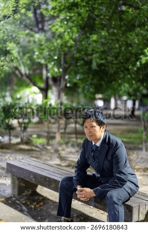Office Worker Finding Resolve on a Park Bench at Night