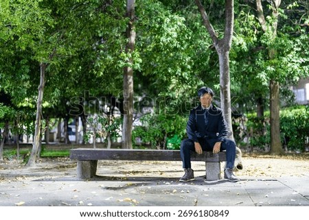 Office Worker Finding Resolve on a Park Bench at Night