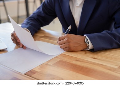 Office Worker Hands Sorting Out Documents At Desk. Male Model Hands With Pen Arranging Documents And Signing Papers At Table. Office Work Concept