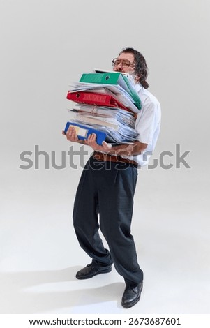 Office worker holding huge stack of binders and documents, being completely buried and overwhelmed by endless paperwork. Concept of bureaucracy, tasks, deadlines, overworking