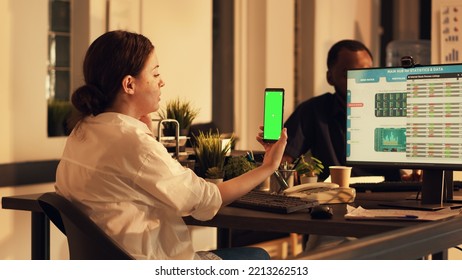 Office Worker Looking At Greenscreen Template On Mobile Phone, Using Isolated Mockup Background And Stock Market Trade Statistics. Working With Blank Copyspace On Smartphone. Tripod Shot.