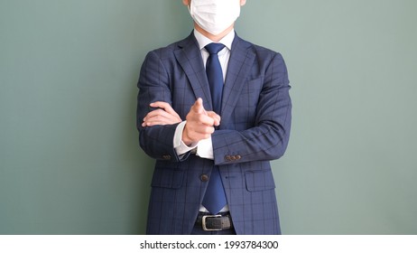 Office worker man wearing a mask to be careful with his finger