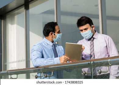 Office worker meeting with face mask quarantine from coronavirus or COVID-19 - Powered by Shutterstock