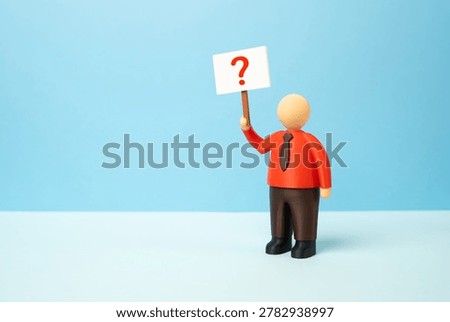 An office worker with a poster and a question mark. What to do next, which career to choose. Answers to questions, guidance and professional uncertainty.