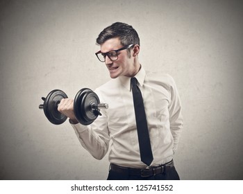 Office worker raising a dumbbell - Powered by Shutterstock