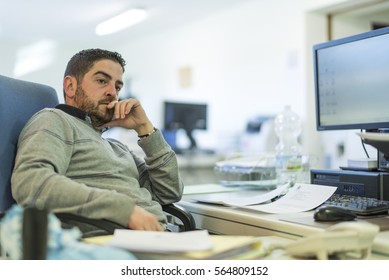 Office Worker In Real Office Working In Files And Thinking