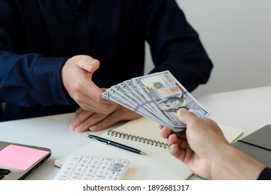 office worker receiving salary from boss.