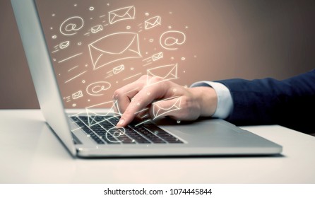 An office worker sending emails and communication with clients with the help of a portable laptop on desk concept - Shutterstock ID 1074445844