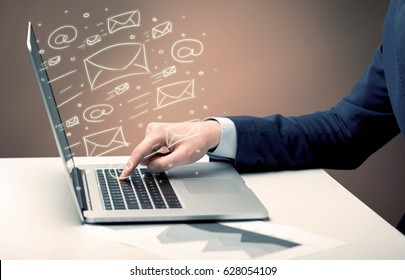 An office worker sending emails and communication with clients with the help of a portable laptop on desk concept - Shutterstock ID 628054109