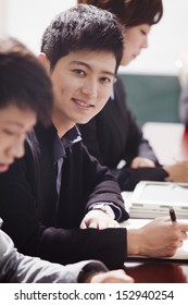 Office Worker Smiling and Looking at Camera