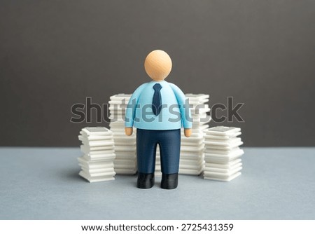 An office worker and stacks of papers and documents. Paperwork and reporting. Bureaucracy and the burden on staff reducing efficiency, motivation and time for productive and creative work tasks