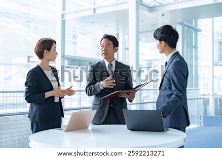 Office worker standing in front of a computer
