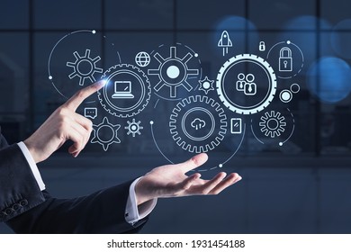 Office worker touching a network symbols, double exposure on background dark office business interior with windows. Concept of business process - Shutterstock ID 1931454188