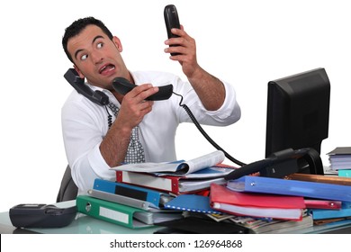 Office Worker Trying To Answer Multiple Phones