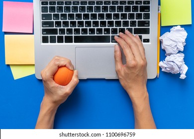 Office Worker Typing Email On Computer, Feels Stressed And Nervous, Holds A Stress Ball In Her Hand