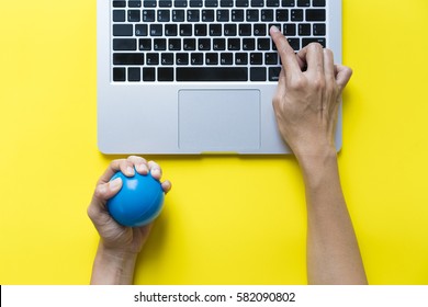 Office Worker Typing Email On Computer, Feels Stressed And Nervous, Holds A Stress Ball In Her Hand