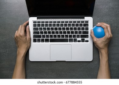 Office Worker Using Computer, Feels Stressed And Nervous, Holds A Stress Ball In Her Hand