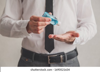 Office worker using tube of hand sanitizer gel dispenser, coronavirus Covid-19 at public places. Antiseptic, Hygiene and healthcare concept - Powered by Shutterstock