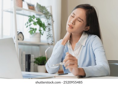 Office workers have neck pain from bad posture during sitting and work. - Powered by Shutterstock