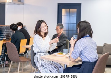 Office Workers Having Lunch At A Company Cafeteria