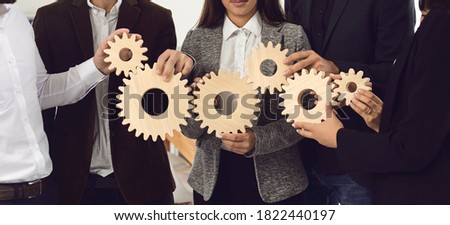Office workers joining cogwheels into working system. Concept of effective business management, collaboration, teamwork and taking responsibility. Banner, header, hero image for company website design