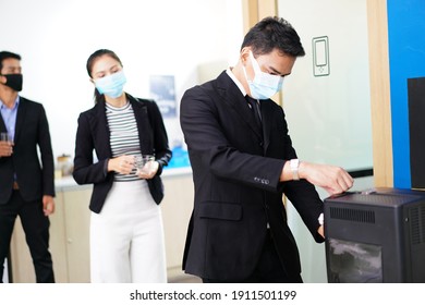 Office Workers Queue Up To Press Coffee By Standing Social Distances To Avoid The Spread Of COVID.