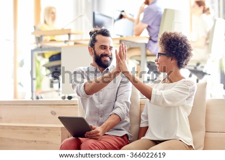 office workers with tablet pc making high five