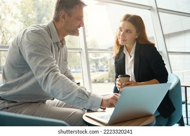 Office workers are viewing working material in a laptop