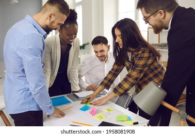 Office workflow planning organization or training process concept. Mixed race diverse creative business team or high student group brainstorming developing plan using color sticker labels for notes