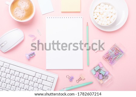 Office workplace desk table with computer, supplies, coffee and marshmallow in pastel colors. Top view - Image