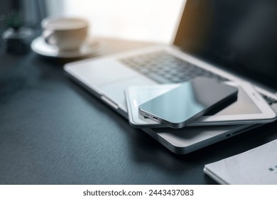 Office workplace with laptop and smart phone on wood table. Workspace, desktop computer, office supplies, houseplant and books at office. desk work concept. laptop Comfortable work table in office.