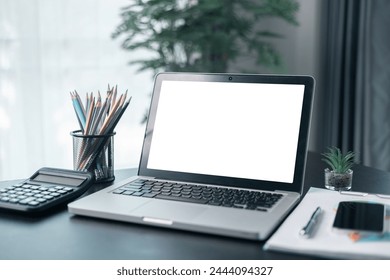 Office workplace with laptop and smart phone on wood table. Workspace, desktop computer, office supplies, houseplant and books at office. desk work concept. laptop Comfortable work table in office. - Powered by Shutterstock