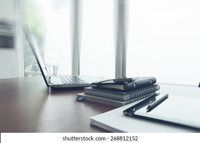 Office workplace with laptop and smart phone on wood table - Shutterstock ID 268812152