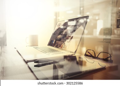 Office Workplace With Laptop And Smart Phone On Wood Table And London City Blurred Background

