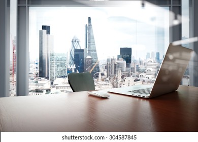 Office workplace with laptop and smart phone on wood table with london city background  - Powered by Shutterstock