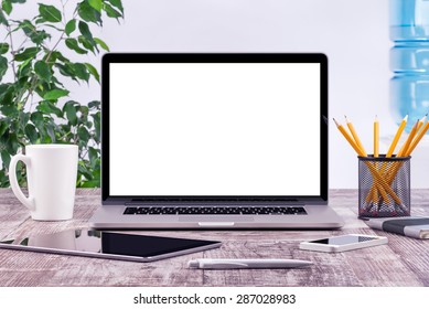 Office Workplace With Open Laptop Mockup Tablet Computer And Smartphone On The Wooden Desk. For Design Presentation Or Portfolio. All Devices In Full Focus.