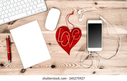 Office Workplace with Red Heart, Keyboard, Tablet PC, Phone, Headphones. Valentines Day concept