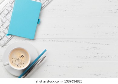 Office workplace table with coffee cup, supplies and computer. Flat lay. Top view with space for your goals - Shutterstock ID 1389634823
